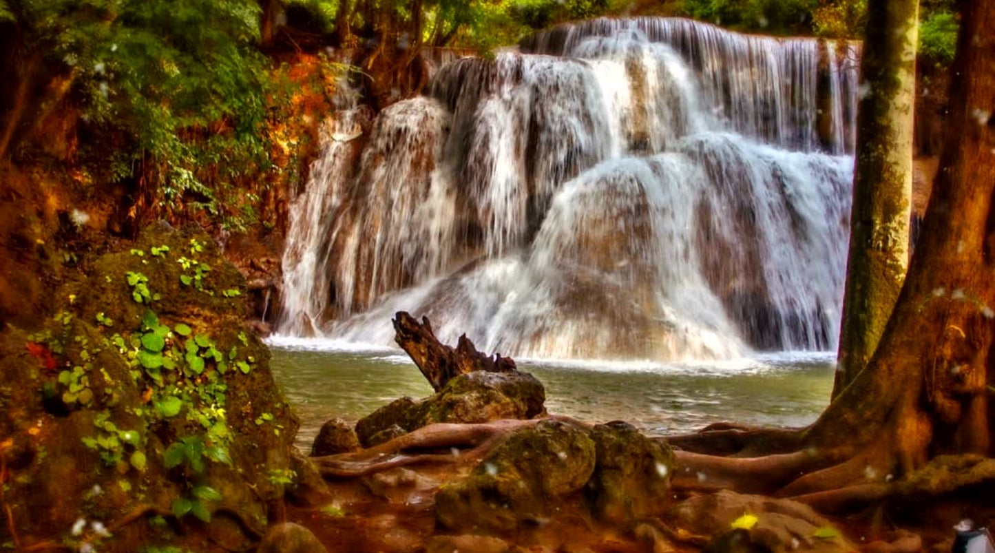 Beautiful image of a water fall gently cascading over large rocks
