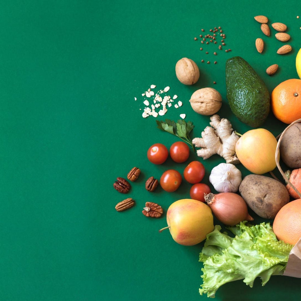 A spilled grocery bag reveals nutrient-dense foods—nuts, avocado, fruits, and greens—highlighting a diet rich in vitamins and minerals to ward off nutrient deficiencies.