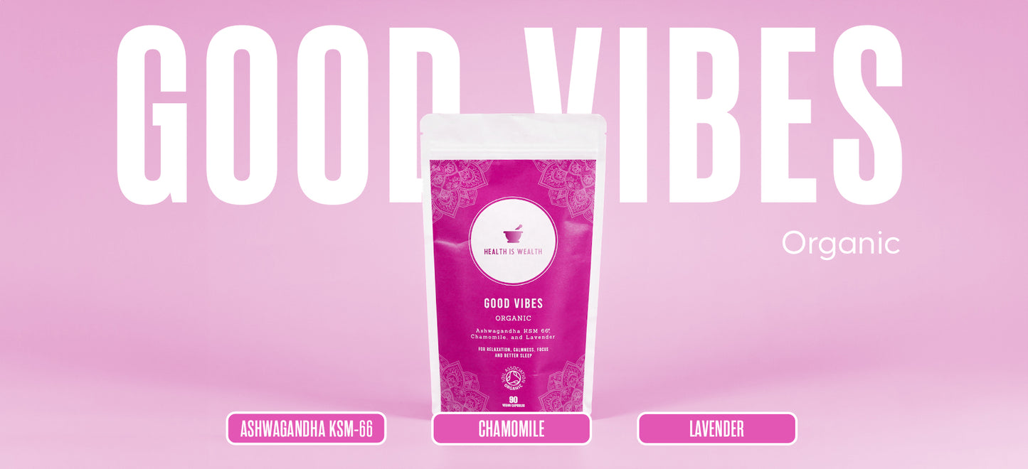 On a gentle purple background, the 'GOOD VIBES' package from Health is Wealth is positioned as a natural stress relief supplement. Its magenta packaging, adorned with white mandala designs, highlights organic supplements like KSM-66 Ashwagandha, Chamomile, and Lavender—key ingredients known for their calming properties. Marketed as stress relief capsules, this organic plant supplement promotes relaxation, focus, lowers stress and improves sleep.
